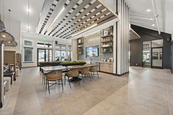 A modern dining room with a large table and chairs.
